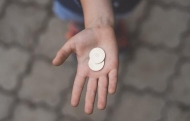 Person with coins in their hand